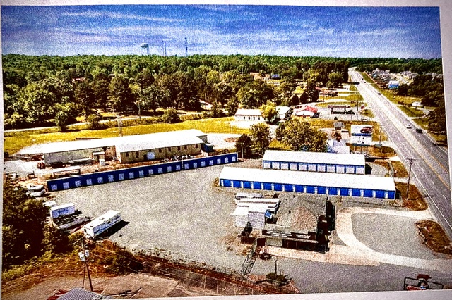 Aerial view of the Ninety Ten Storage facility with multiple blue buildings along Hwy 65 N in Conway