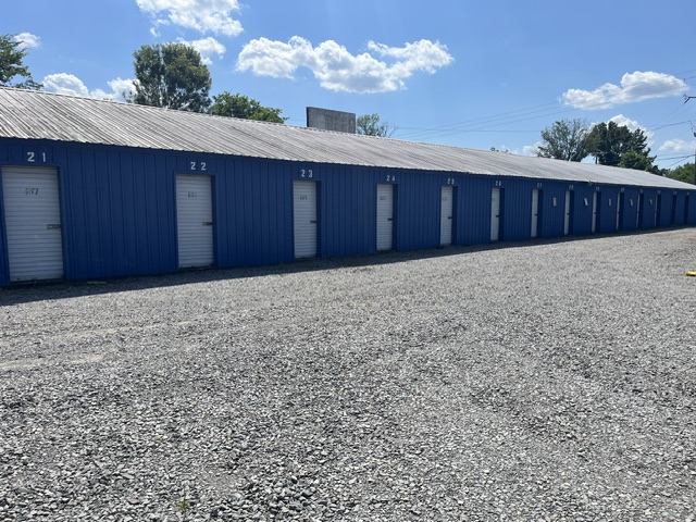 Row of numbered blue storage units with a metal roof